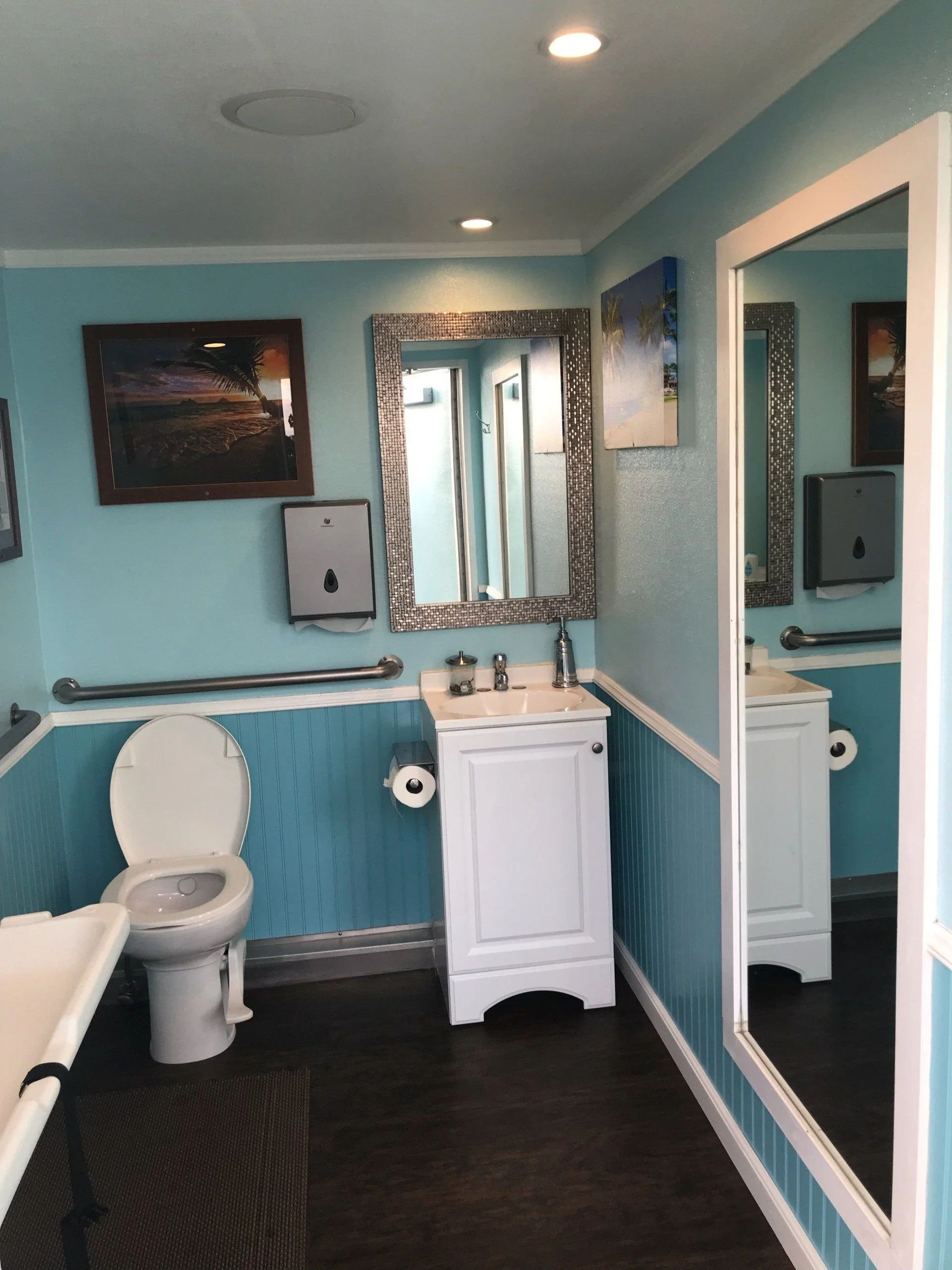 Toilet and handwash sink inside an event restroom trailer.