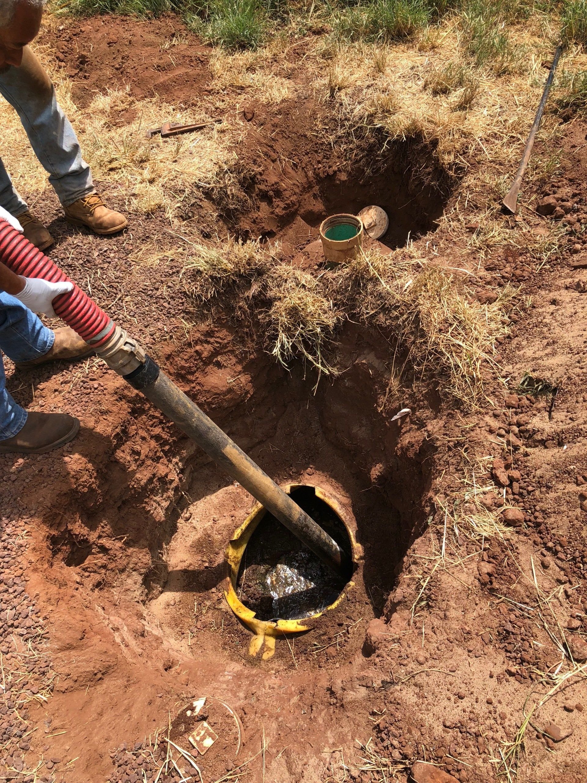 An exposed access vault in a freshly excavated yard.