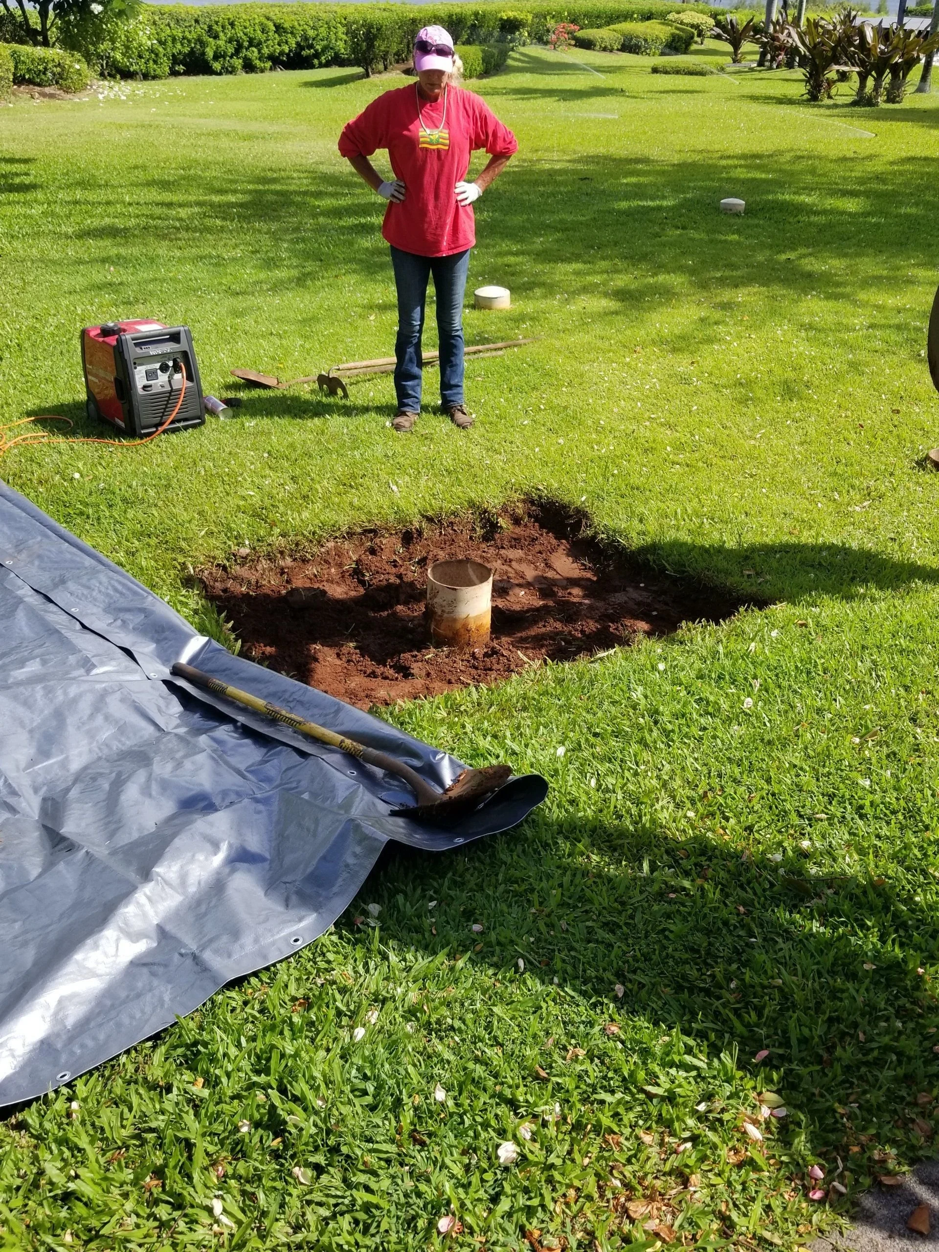 Worker beside an excavated access point.