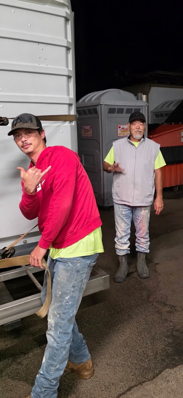 Two Akamai crew members in the equipment yard.