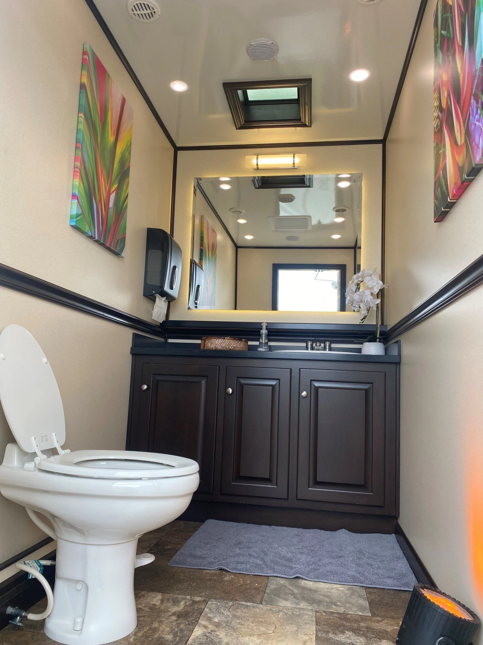 Vanity and toilet in an event restroom trailer.