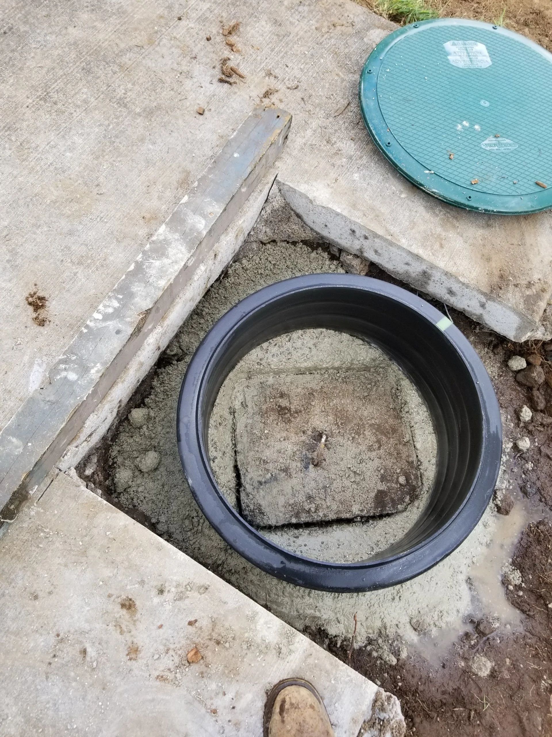 Corrugated riser set into a concrete access opening