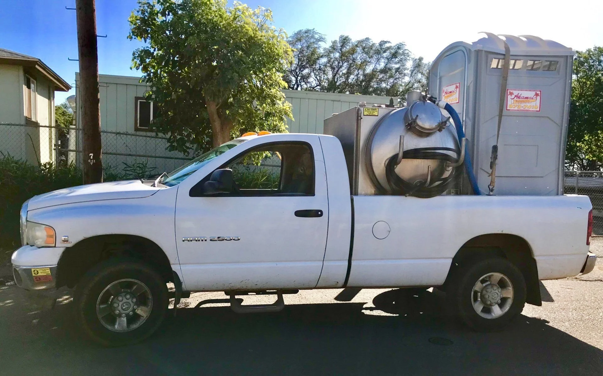 Service truck and portable toilet at a customer location.