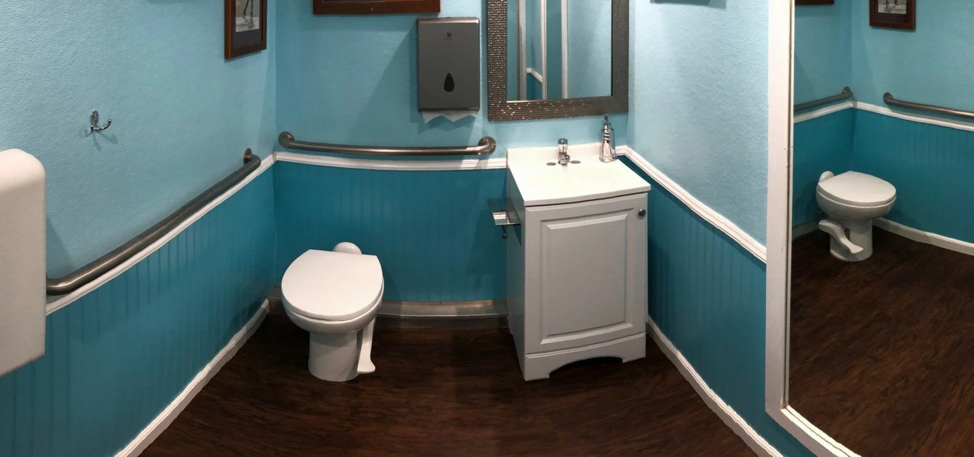 Handwash sink and toilet in an event restroom trailer family suite.