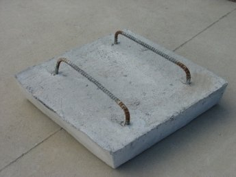 Concrete cover with two lifting handles.