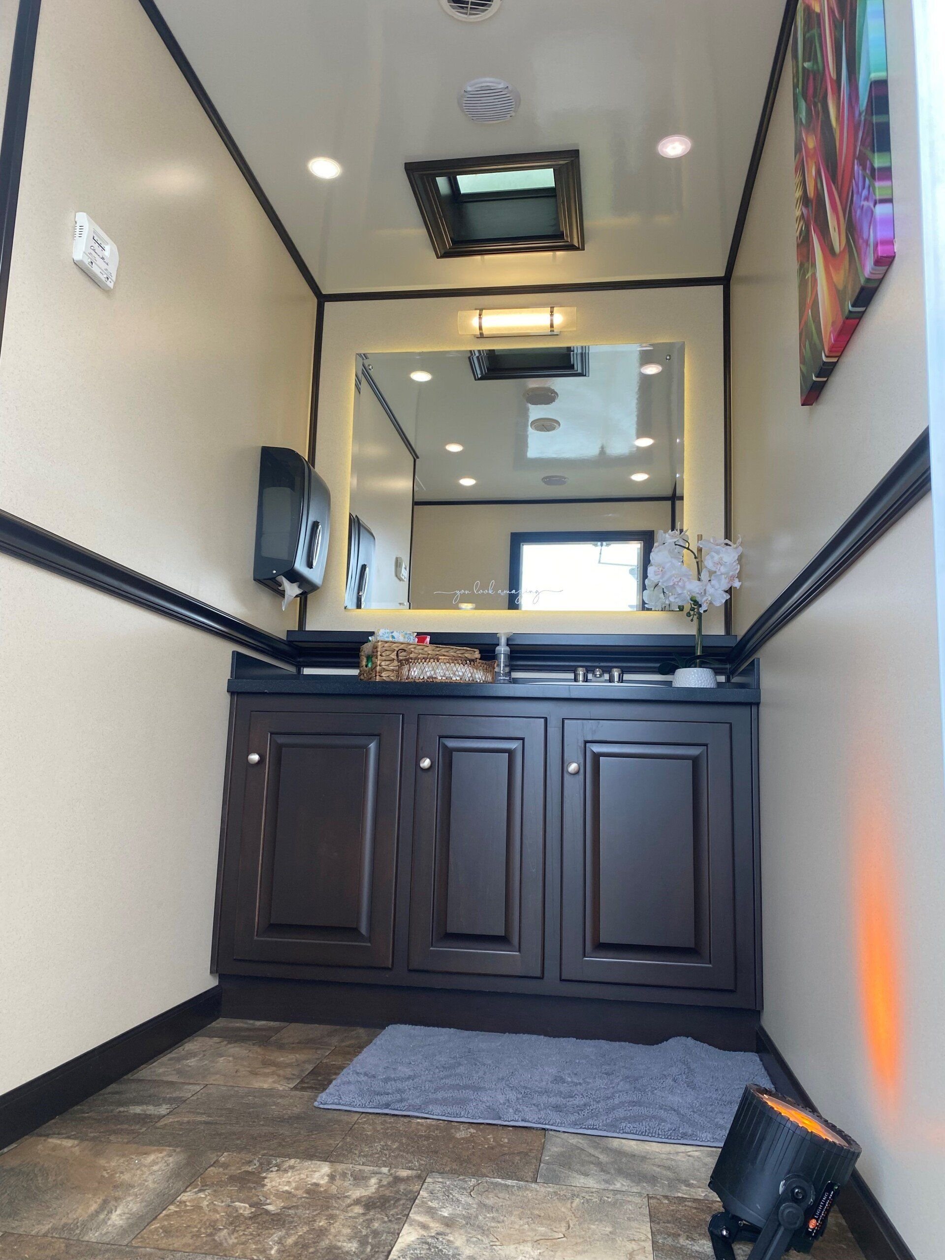 Vanity and urinal in an event restroom trailer.