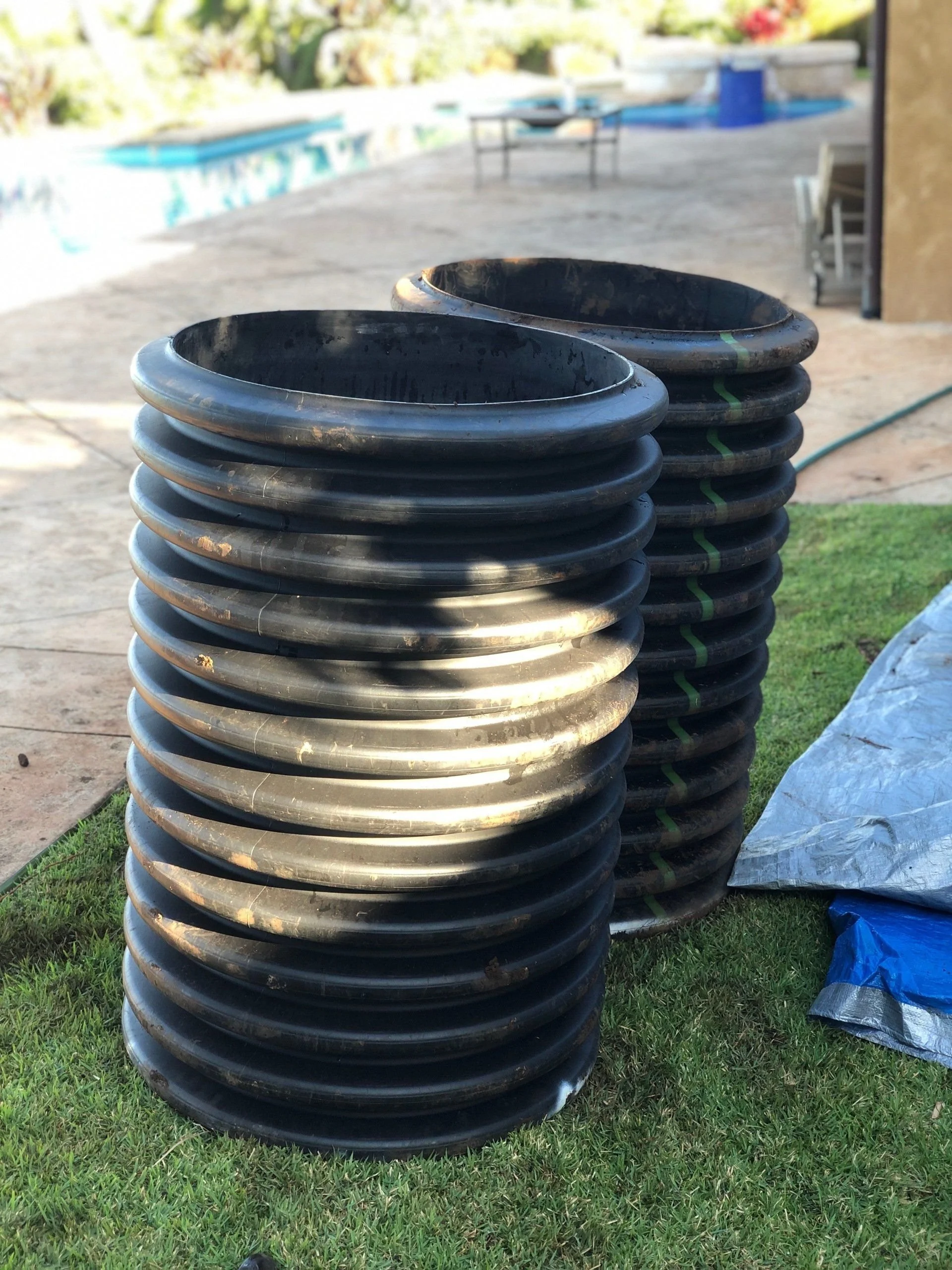 Stacked corrugated riser sections ready for installation.