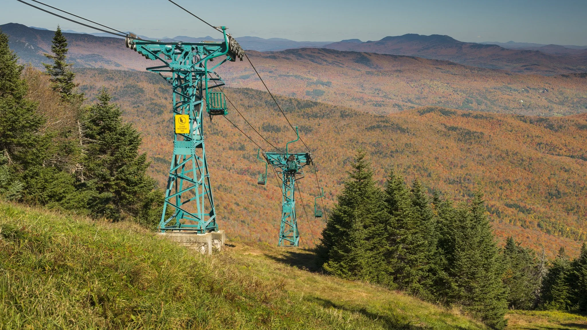 The lift towers stand quiet over the valley.