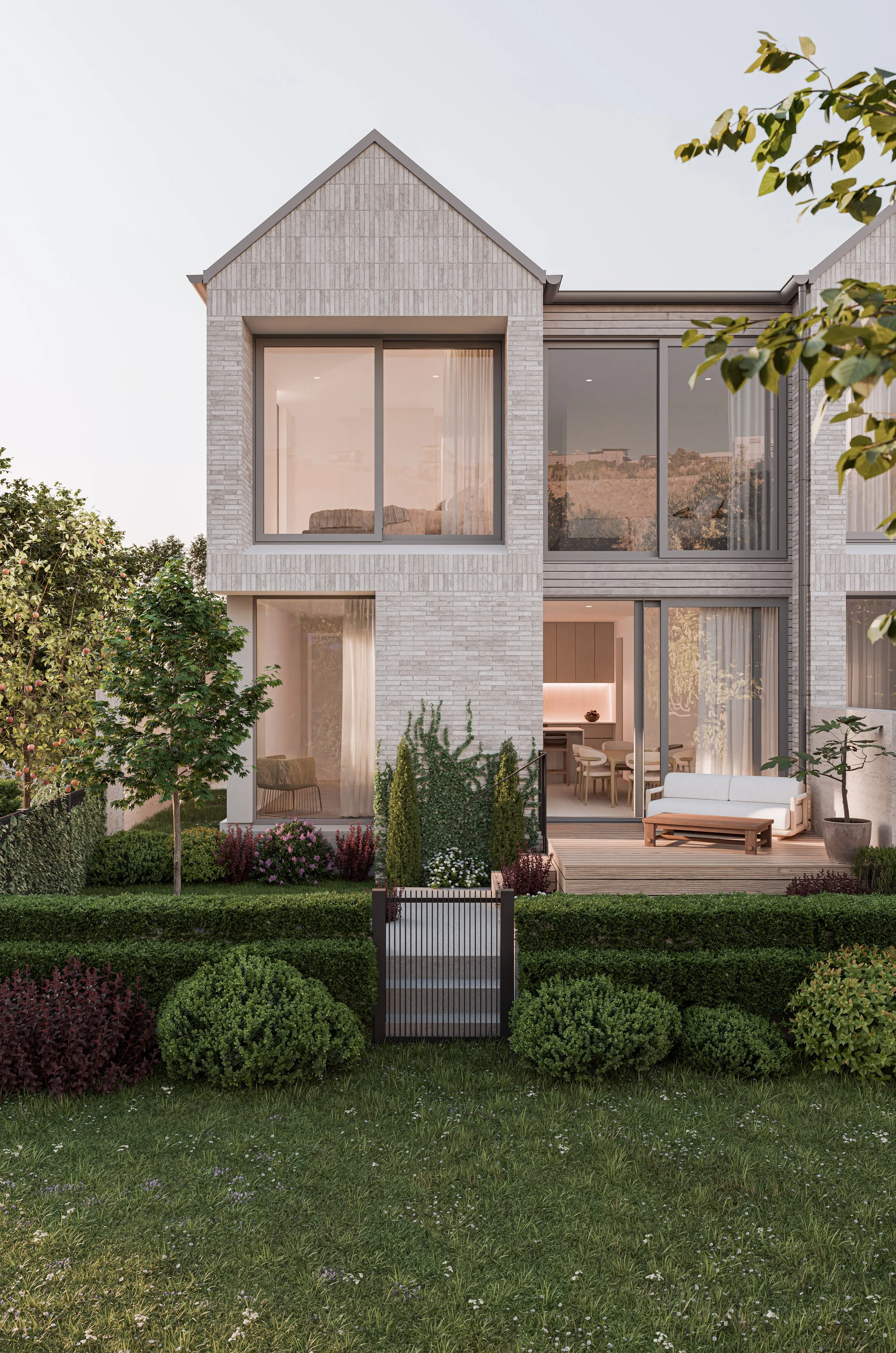 Modern two-story house with large glass windows, patio, and well-maintained garden with shrubs and trees.