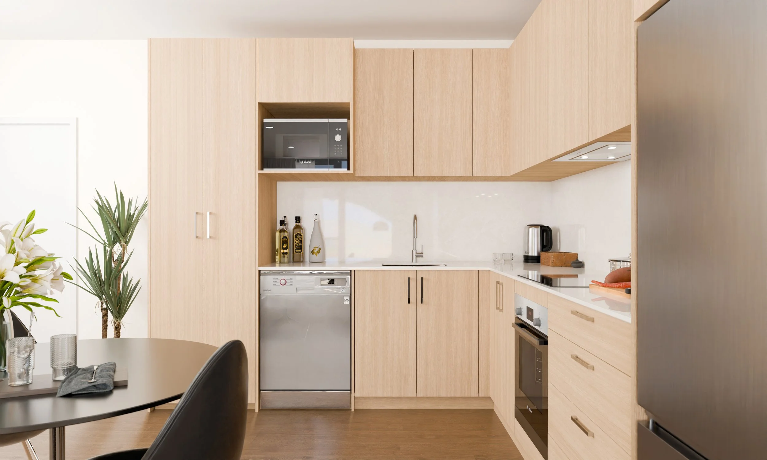 Modern kitchen with light wood cabinets, stainless steel appliances, and white countertops, with a dining table in the foreground.