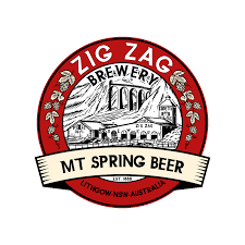 Logo for Zig Zag Brewery featuring a black and white illustration of a bridge inside a red circle with the text 'Zig Zag Brewery' and 'Mt Spring Beer' and 'Lismore NSW Australia'.
