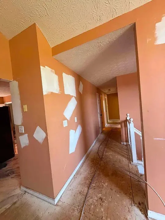 Hallway walls with drywall patches prepared for paint