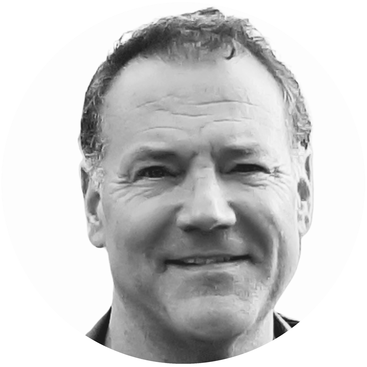 Close-up black-and-white photograph of a smiling middle-aged man with short hair and wrinkles around his eyes.