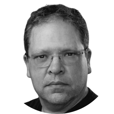 Black and white portrait of a man wearing glasses with short, dark hair.