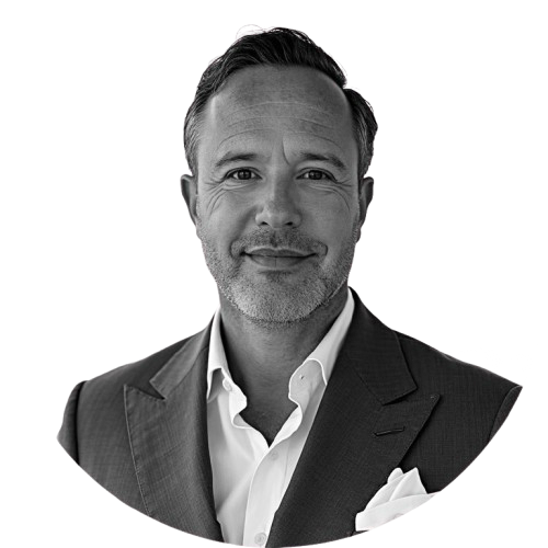 Black and white portrait of a smiling man in a suit and white shirt