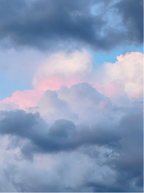 Cloudy sky with dark and pink clouds.