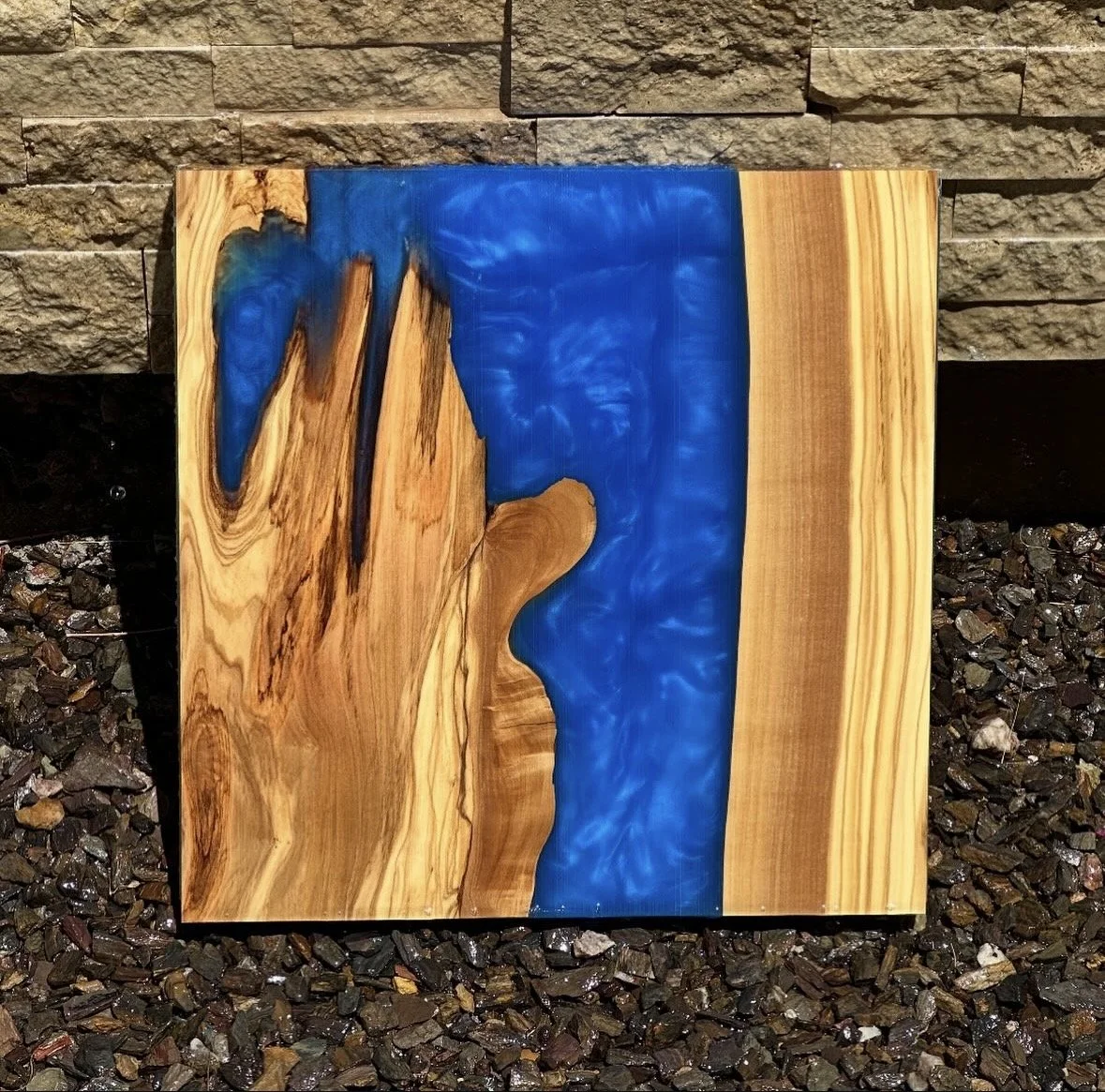 Wood and epoxy plant stand featuring a blue water-like design.