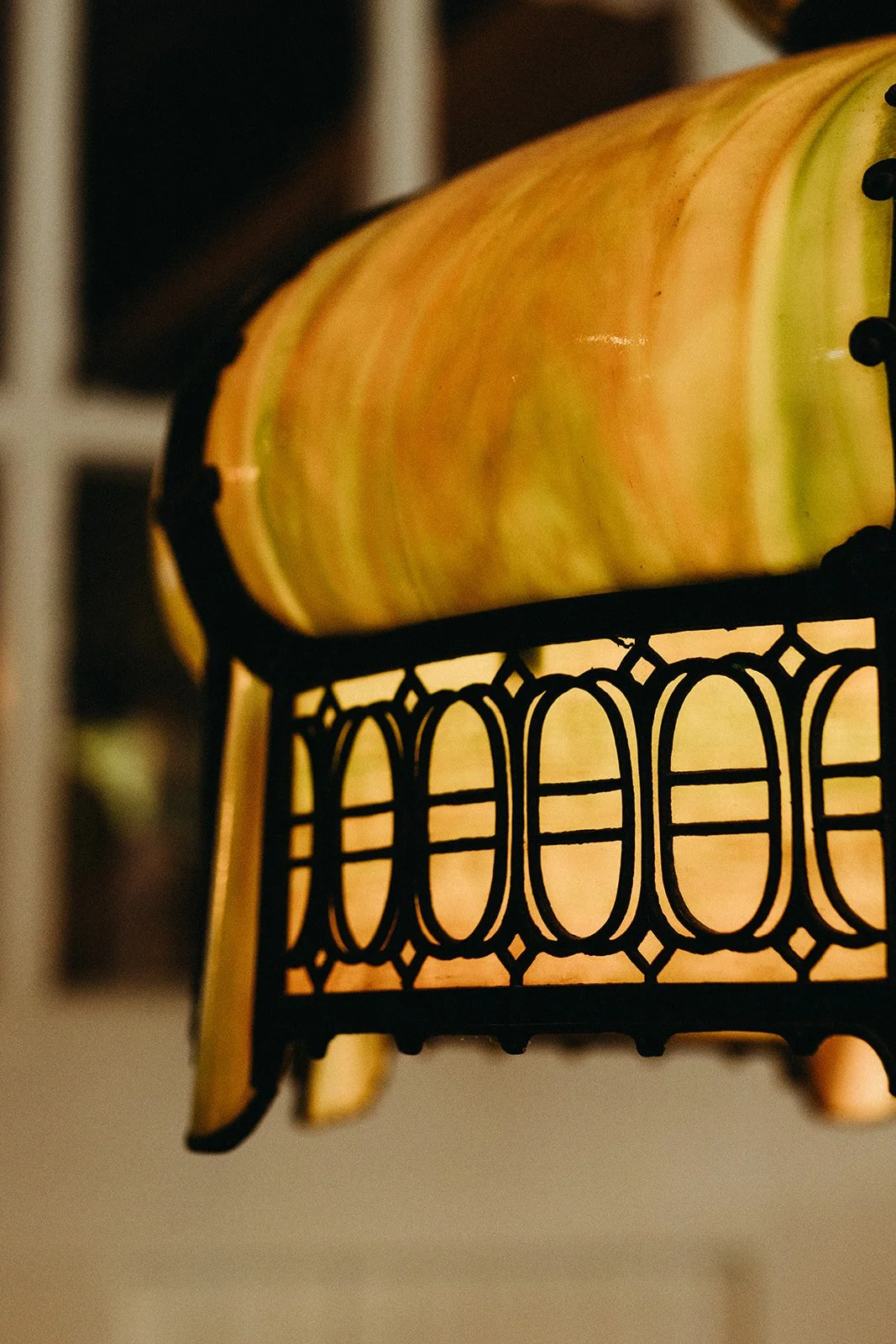 Close-up of a pumpkin-shaped lamp with a black metal decorative frame.