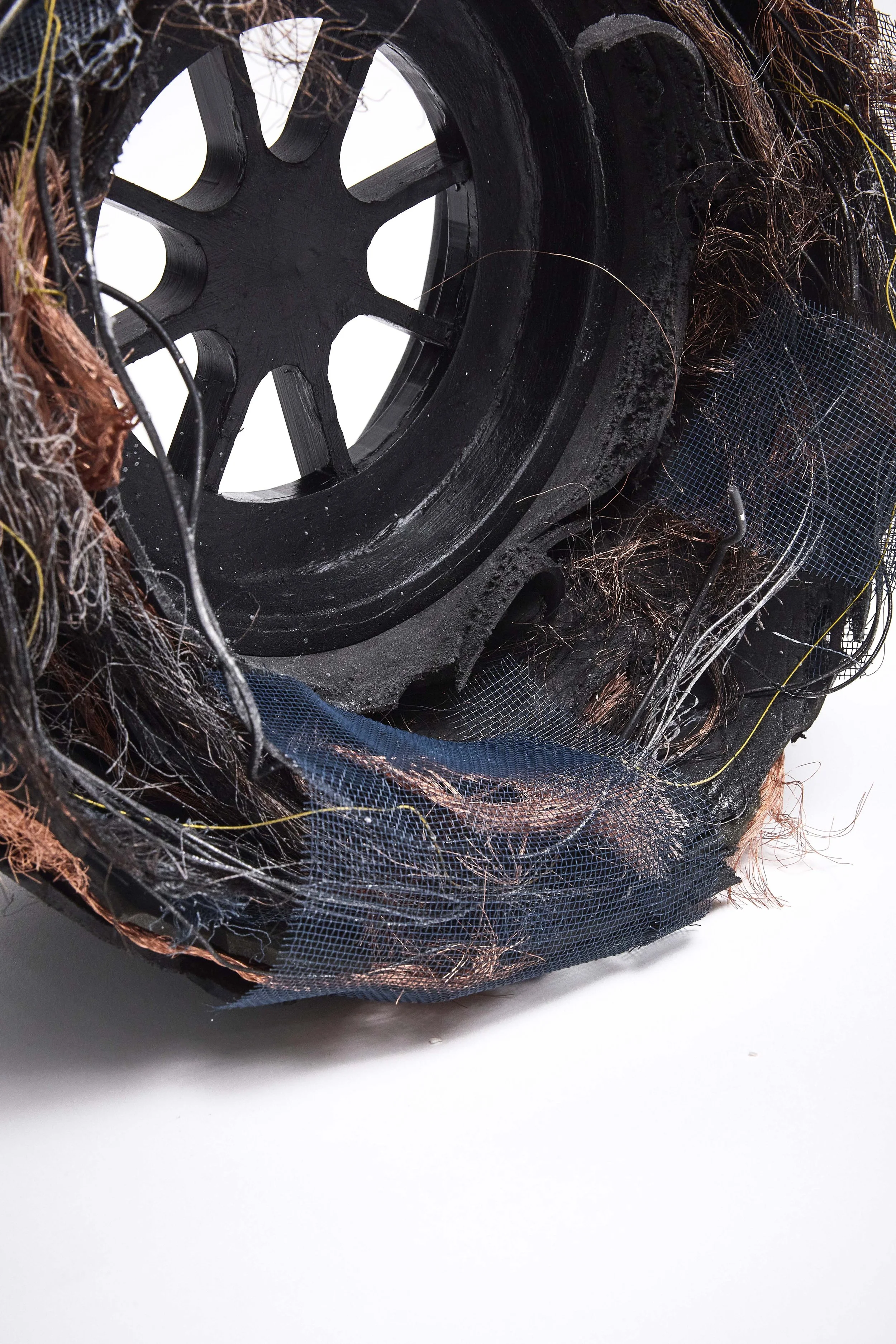 Close-up of a damaged or burned electrical cable with frayed wires and blackened insulation.