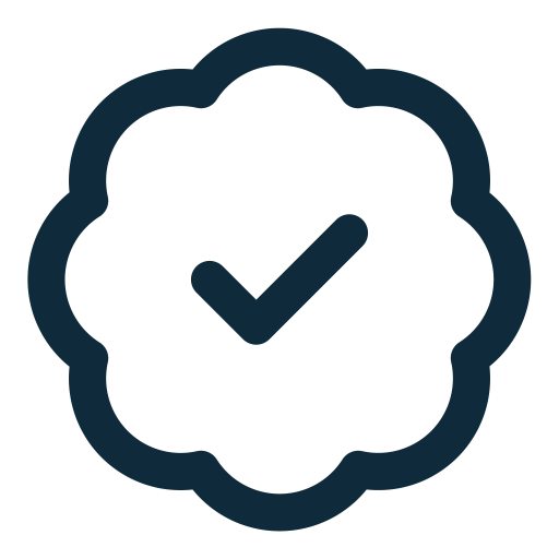 A dark outline of a badge or seal with a check mark inside.
