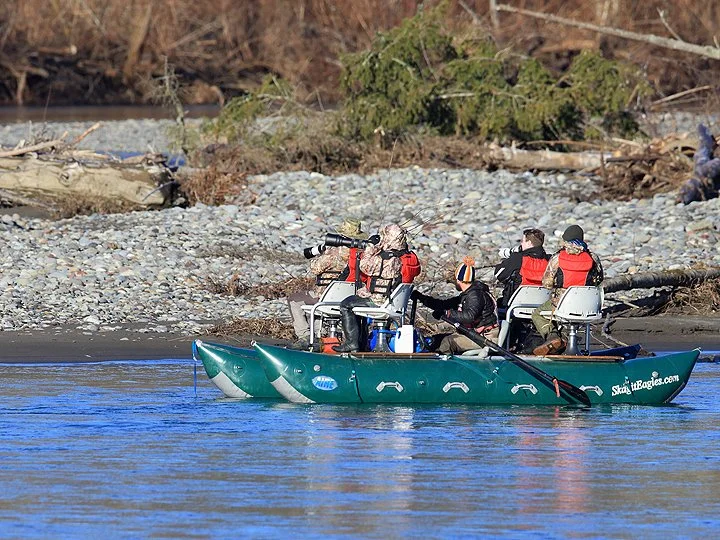 Group of Wild life photographers in a boat taking photos.