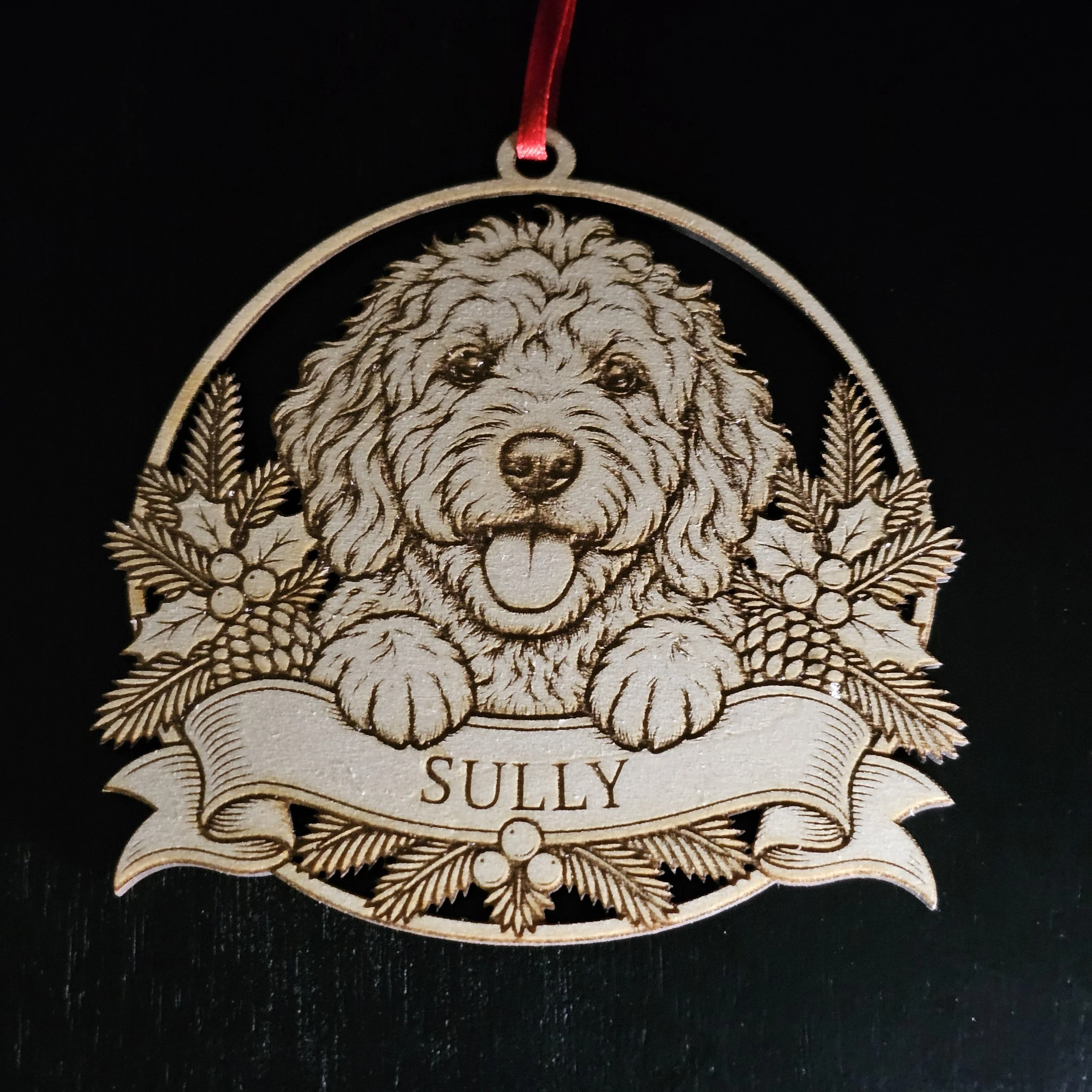 Goldendoodle ornament with name detail against solid black background.