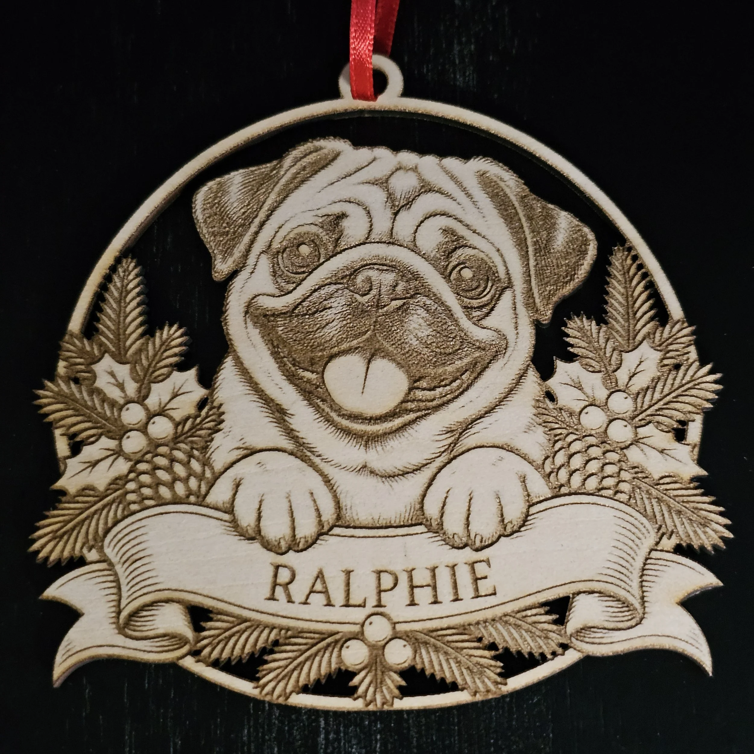 Pug ornament with name detail against solid black background.