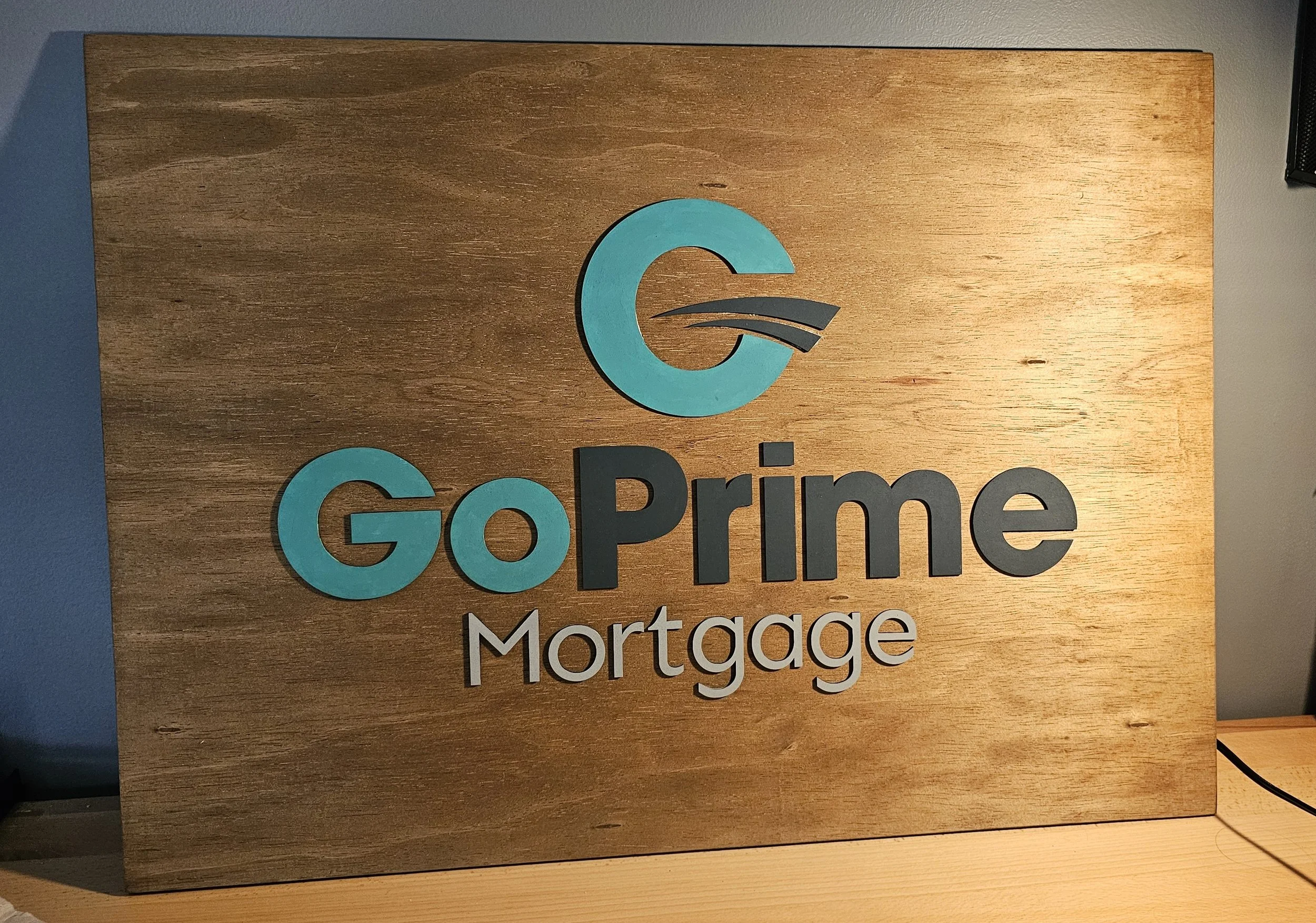 A sign made for a local lender's office wall.