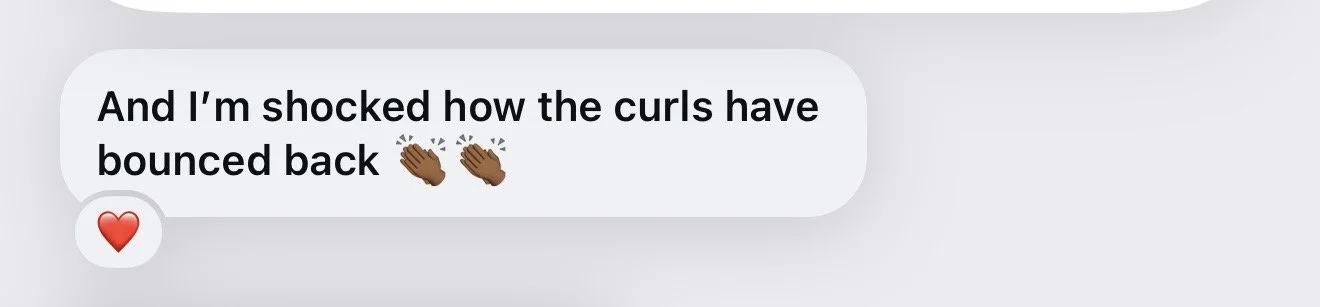 Text message saying: 'And I’m shocked how the curls have bounced back' with clapping hands emojis and a red heart emoji.