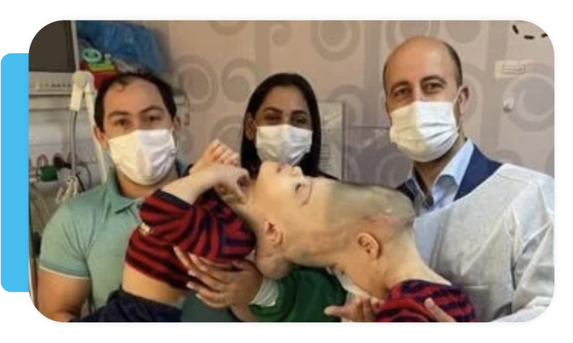 Medical staff in masks and protective gear holding a patient lying in bed