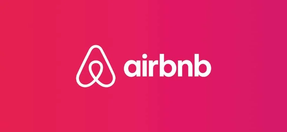 Airbnb logo on a pink background.