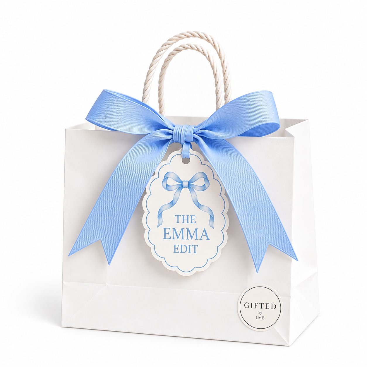 White gift bag with blue ribbon bow and a tag that reads "The Emma Edit" and a small round sticker that says "Gifted by LMB".