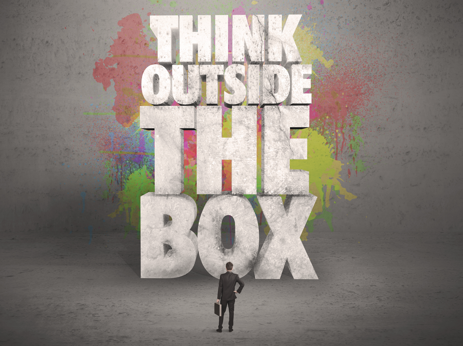 Think Outside The Box Solomon Community Advisors Man in Suit in front of Large Think Outside of the Box Sign with Color Spashes