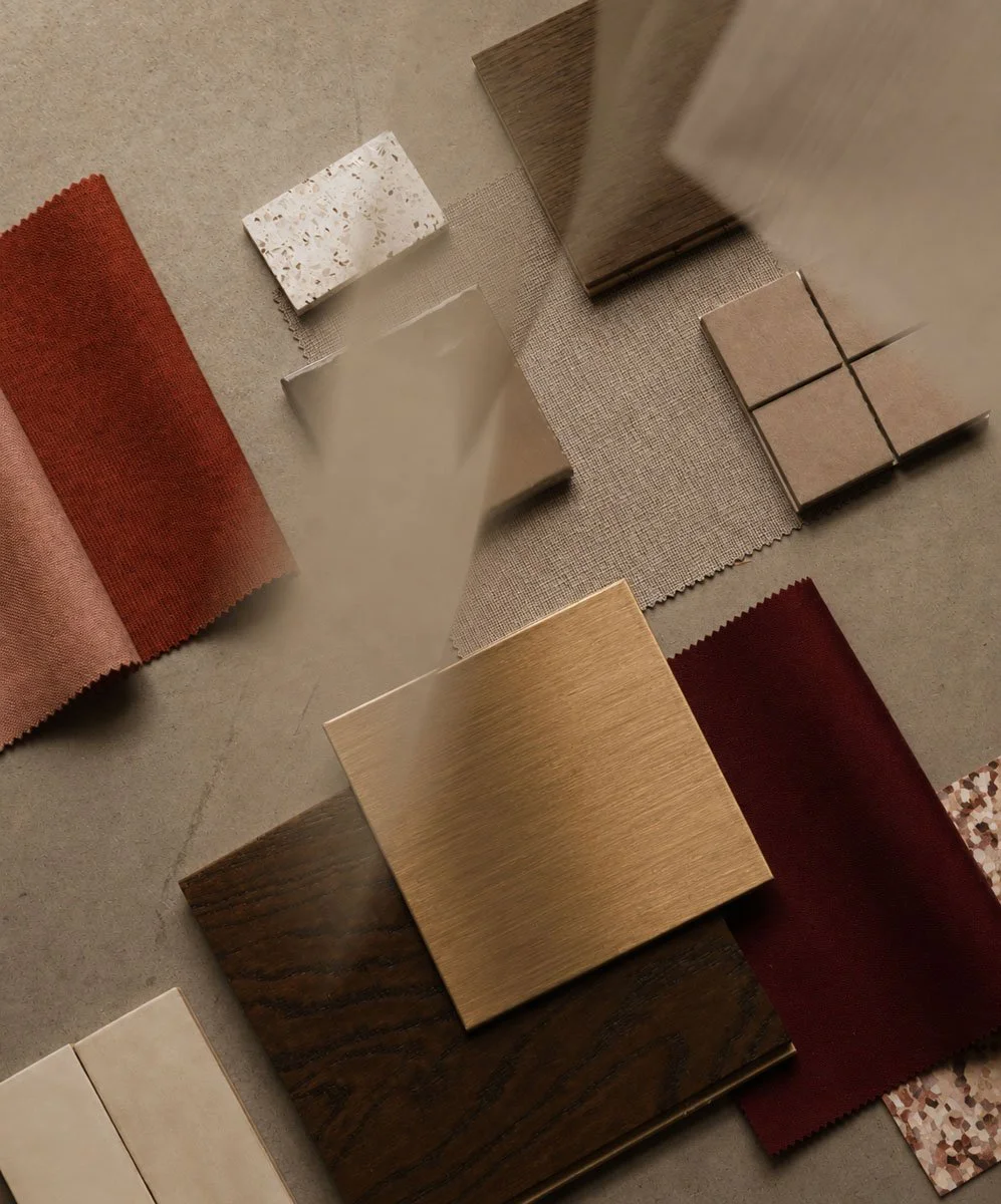 Samples of fabric and material swatches in various colors and textures arranged on a surface.