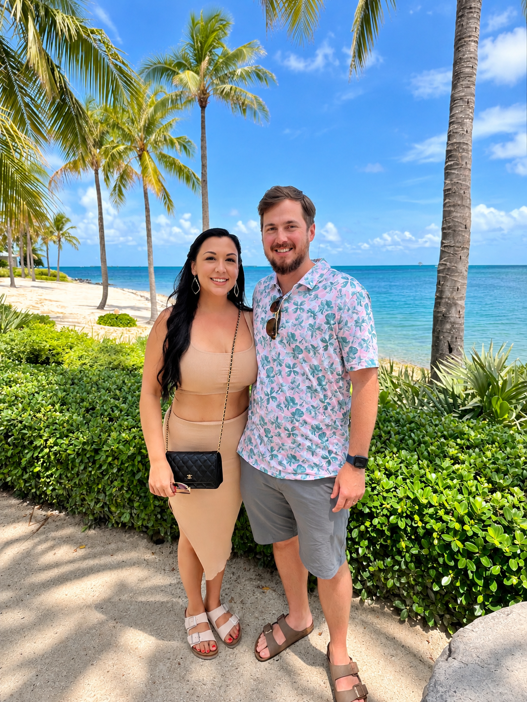 Stephanie and her husband on a palm-lined beach path at Sunset Key in Key West
