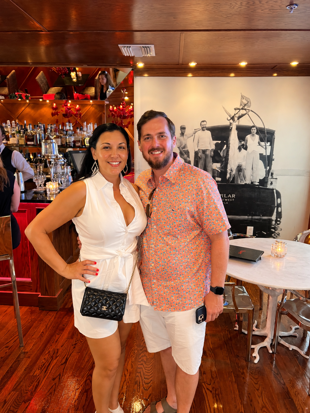 Stephanie and her husband at the bar beneath a Hemingway photo at The Saint Hotel in Key West