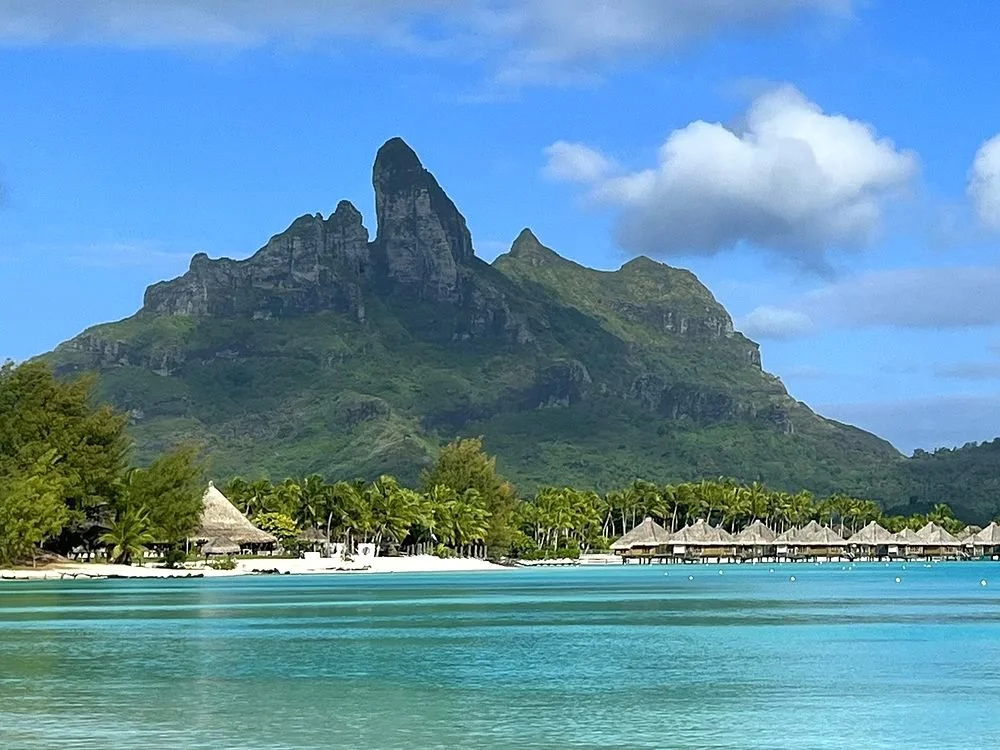 Mount Otemanu rising above a row of overwater villas and Bora Bora's turquoise lagoon