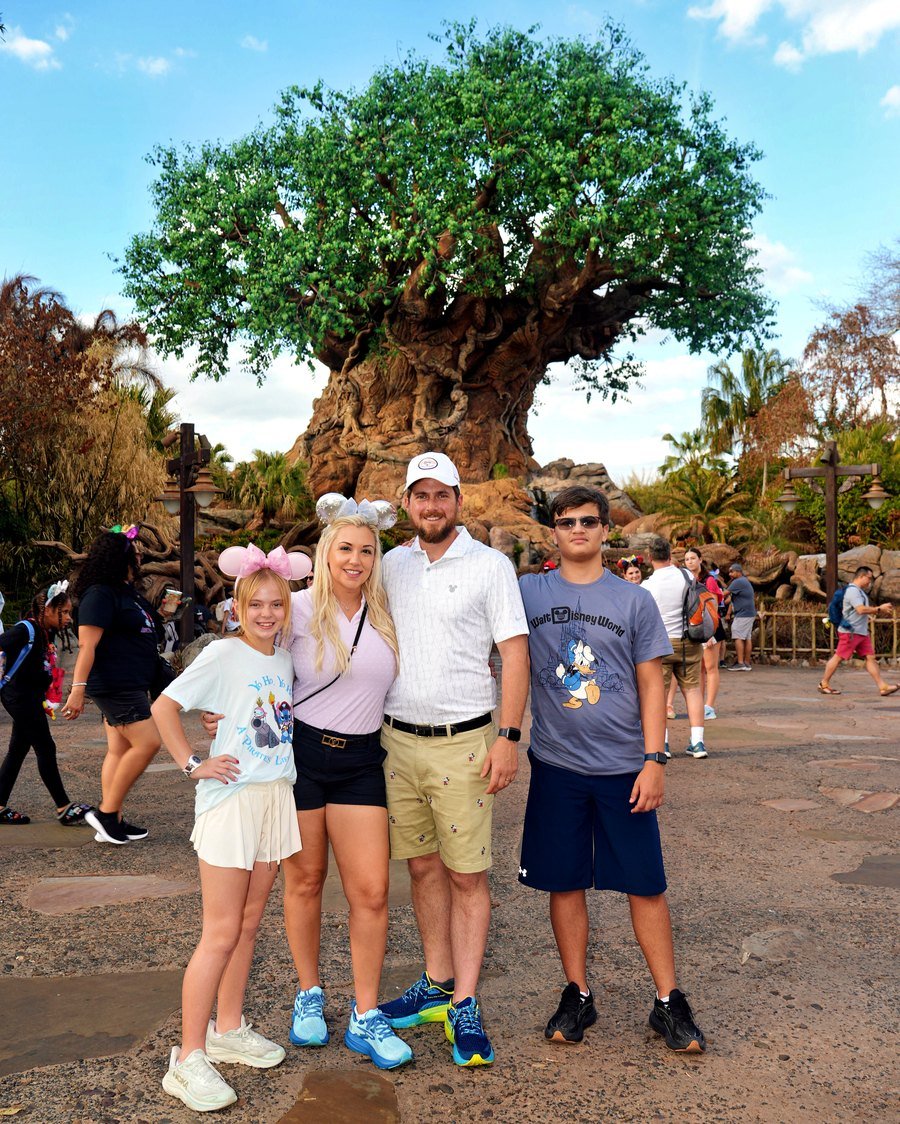 Stephanie and her family in front of the Tree of Life