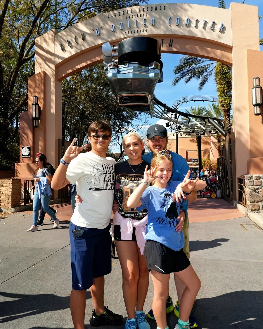 Stephanie and her family in front of Rock ’n’ Roller Coaster