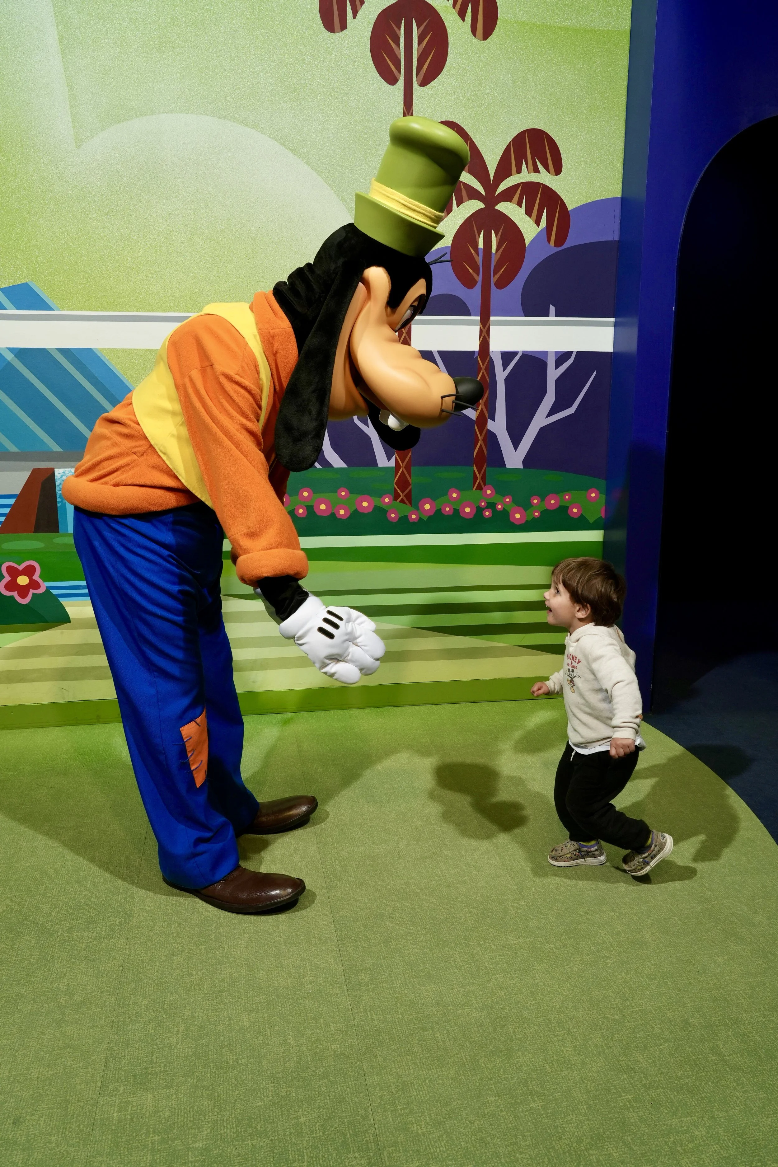 Stephanie's son meeting Goofy at EPCOT
