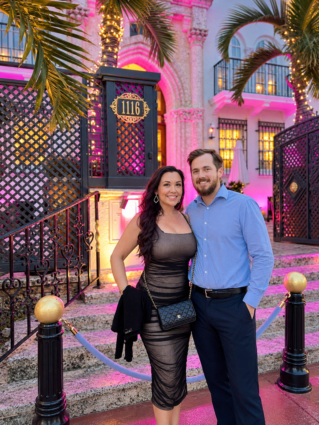 Stephanie and her husband at night outside the 1116 gate of Villa Casa Casuarina, the former Versace Mansion, in Miami Beach