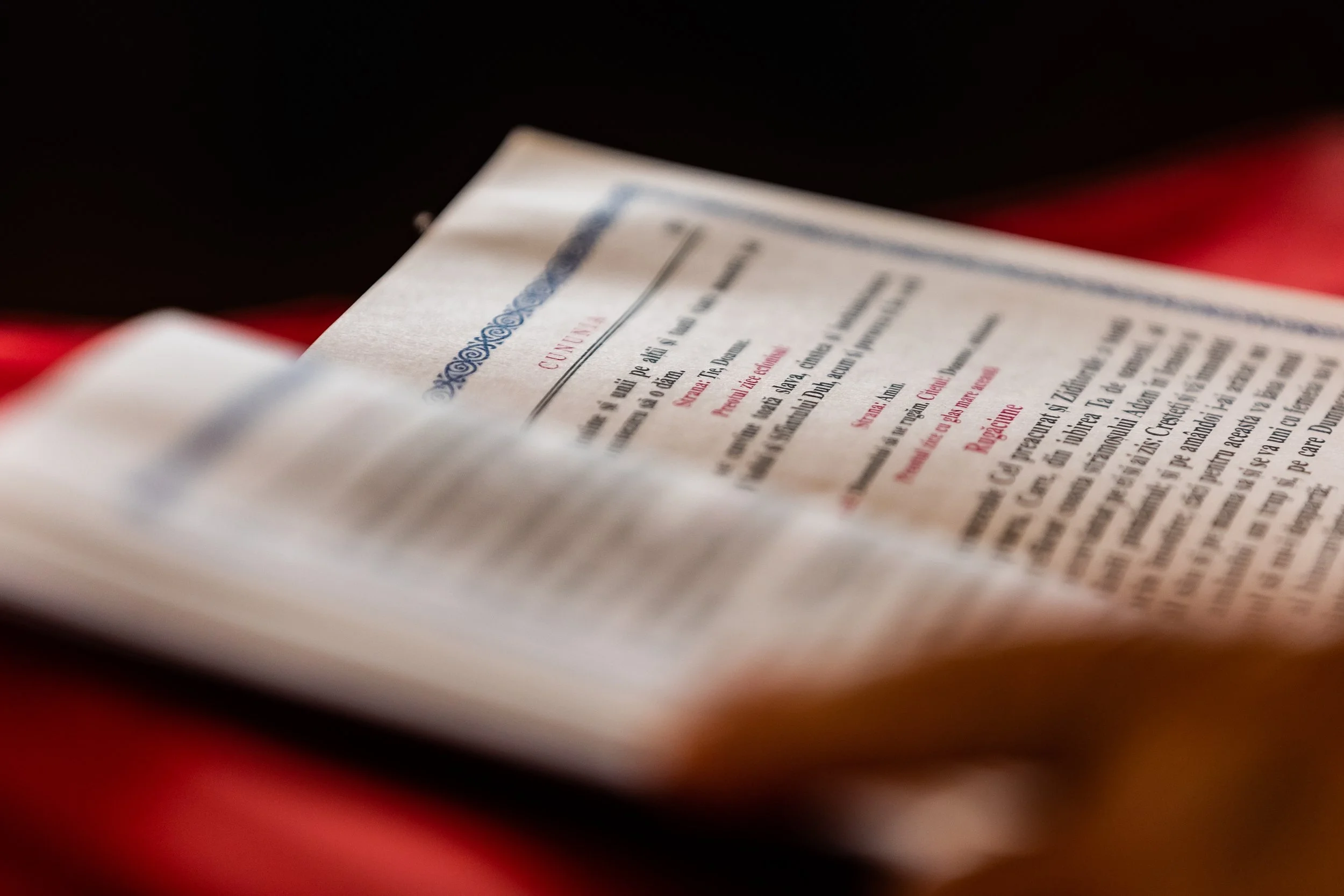 Close-up of a paper or document with printed text, partially blurred and out of focus.
