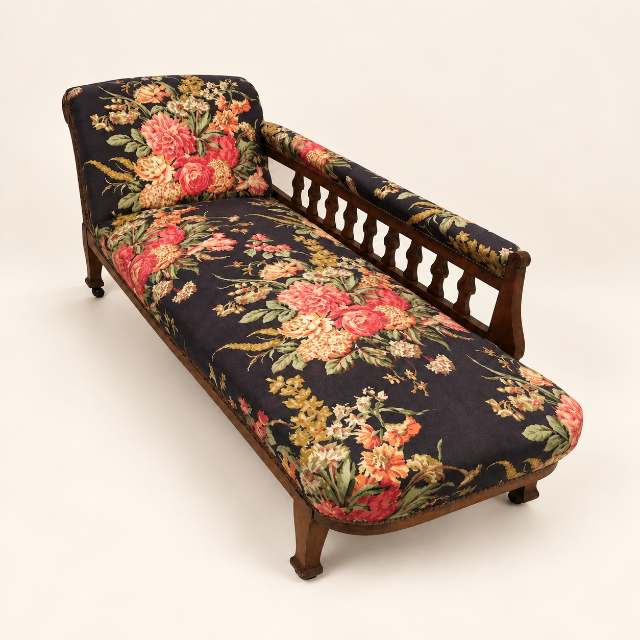 After reupholstery: the chaise longue in dark floral fabric with its carved wooden frame
