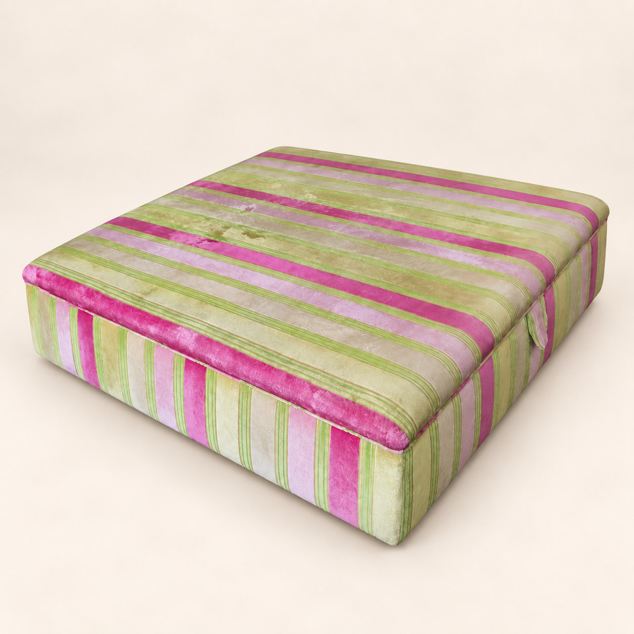 Before reupholstery: rectangular ottoman covered in pink and green striped fabric