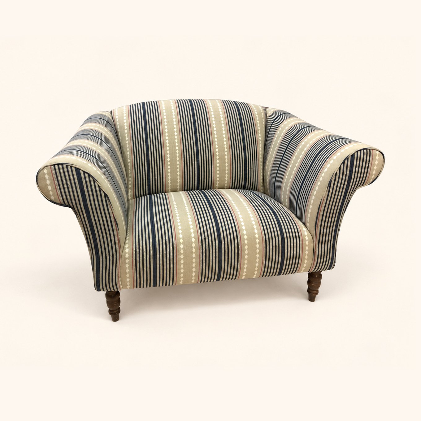 Curved tub chair reupholstered in striped fabric.