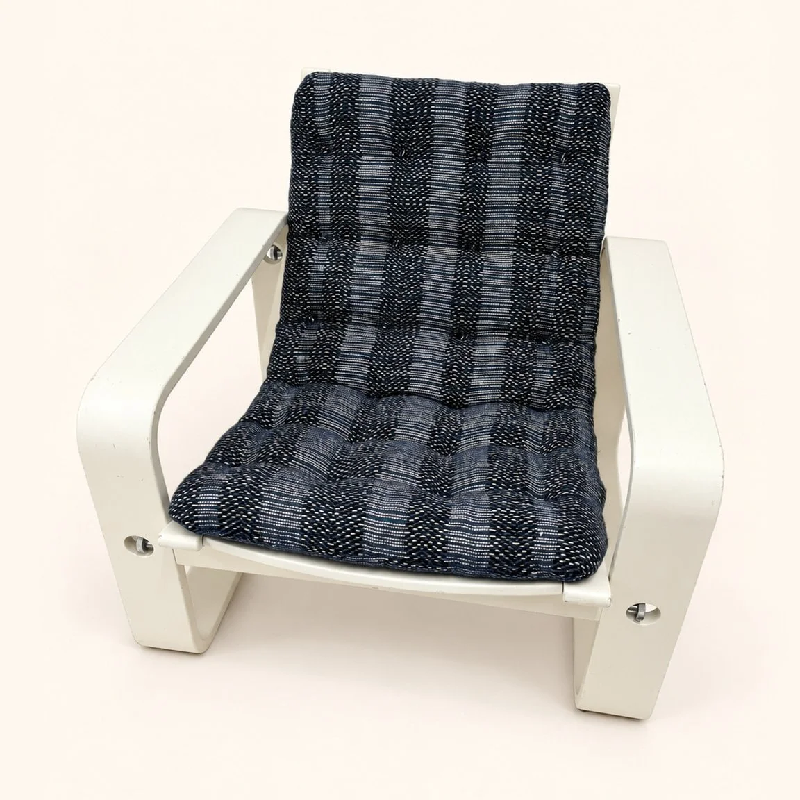 After reupholstery: a white-frame lounge chair with a blue and grey checked seat and back, slender arms and curved runners.