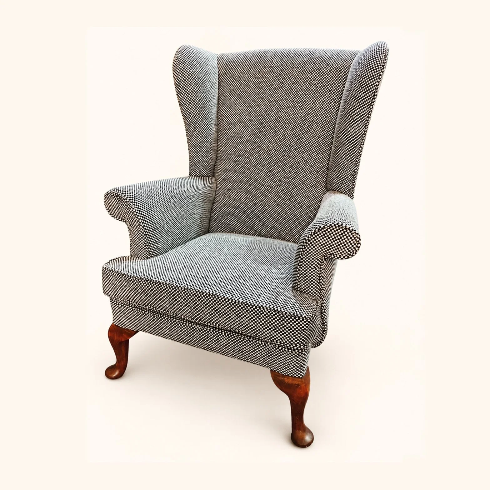 Parker Knoll Armchair after reupholstery in grey patterned fabric, with curved wooden legs.