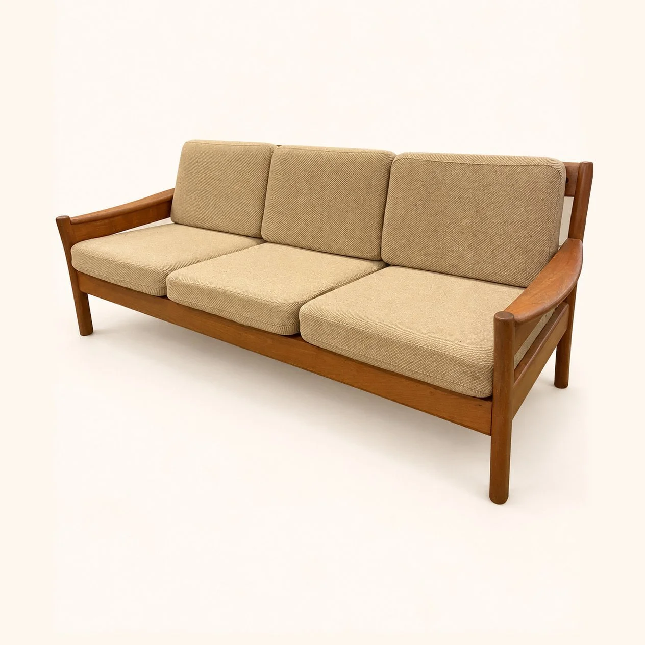 Before reupholstery: a wooden three-seat sofa with beige seat and back cushions, exposed wooden arms and straight legs.