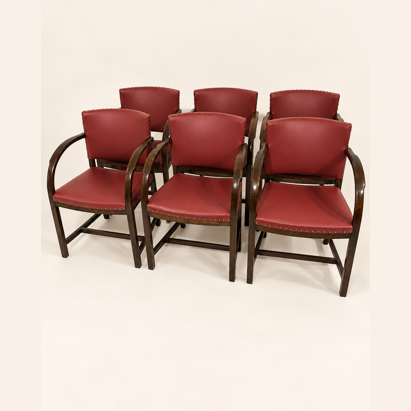After reupholstery: six wooden armchairs with burgundy upholstered seats and backs