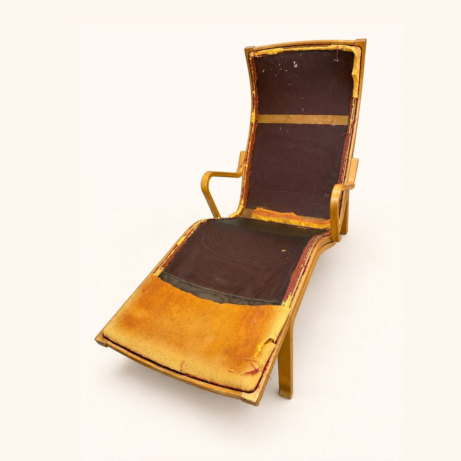 Before reupholstery: a wooden lounge chair with exposed seat and back construction and curved wooden arms.